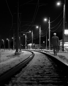 man walking railway track