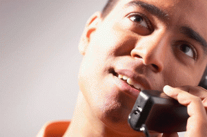 Smiling man talking on telephone