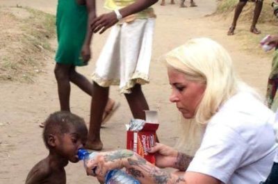 Girl Give Water to Child