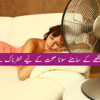 Woman sleeping with fan blowing on her